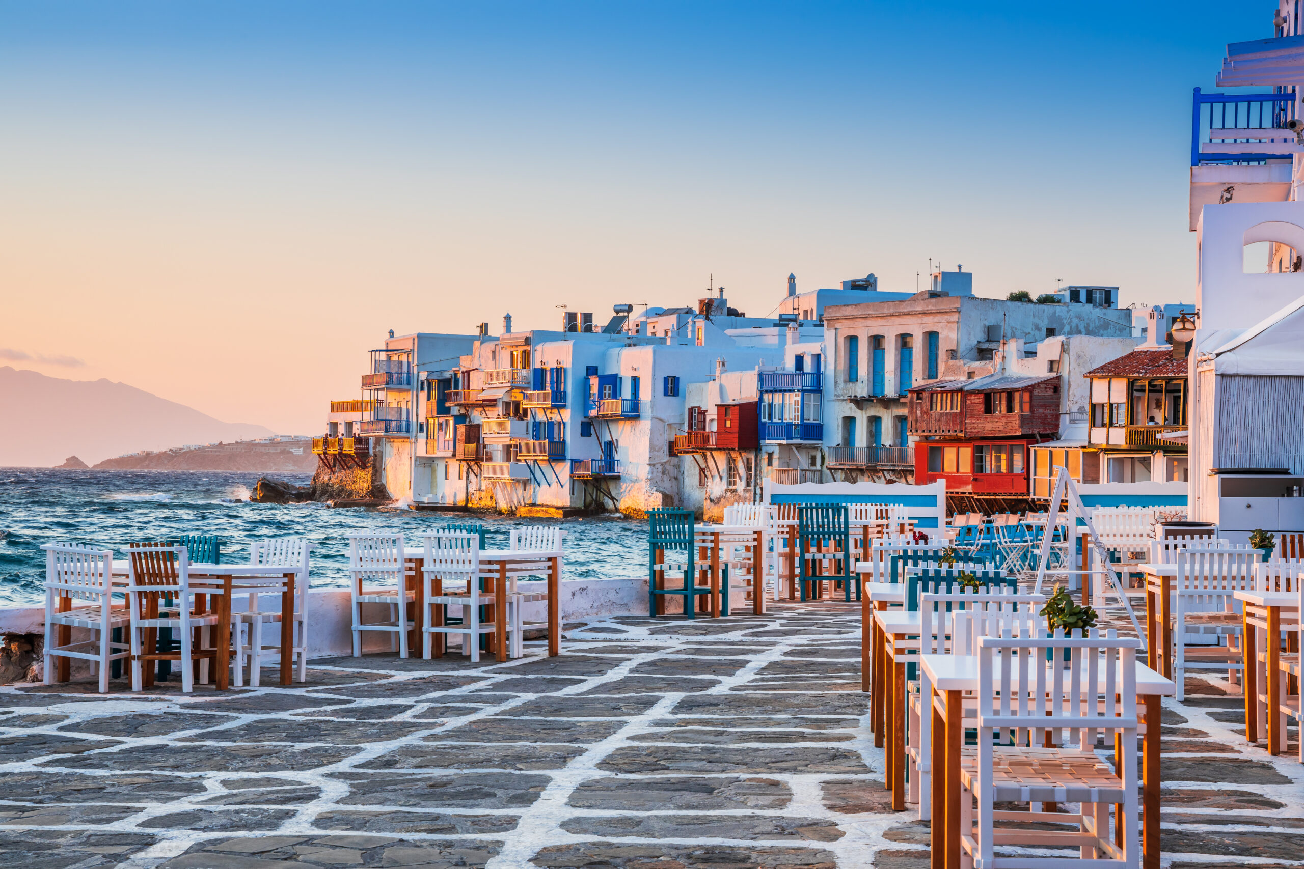 Mykonos with the beautiful white washed houses of little venice under the sunset sun