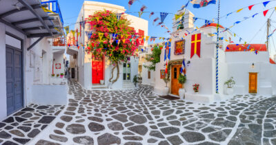 Whitewashed houses with blue details and windows with bougainvillea in Mykonos